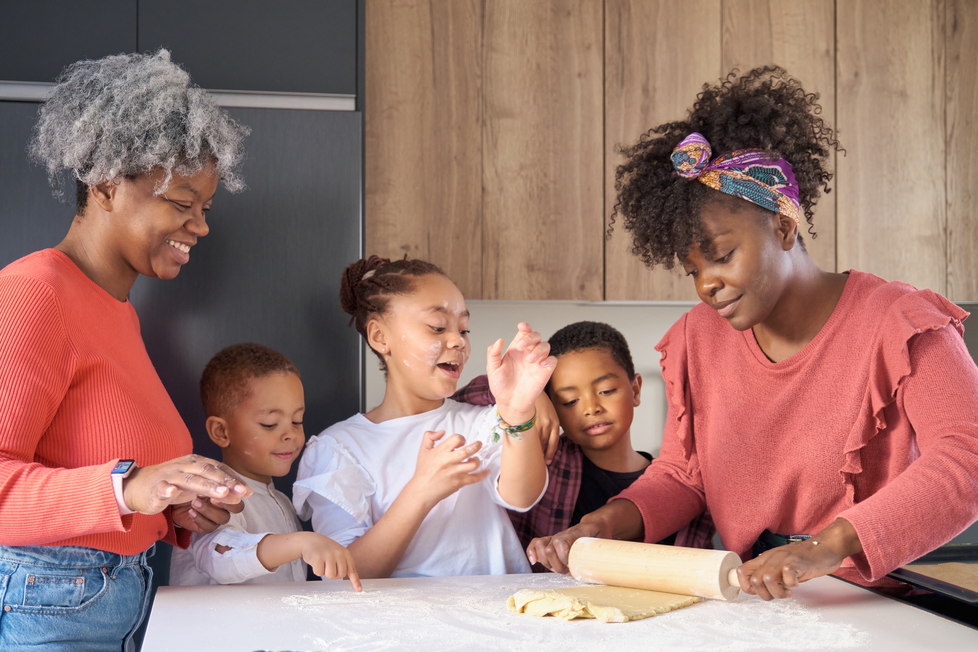 african-happy-family-roll-cookie-dough-out-with-a-rolling-pin-in-the-kitchen-.jpg